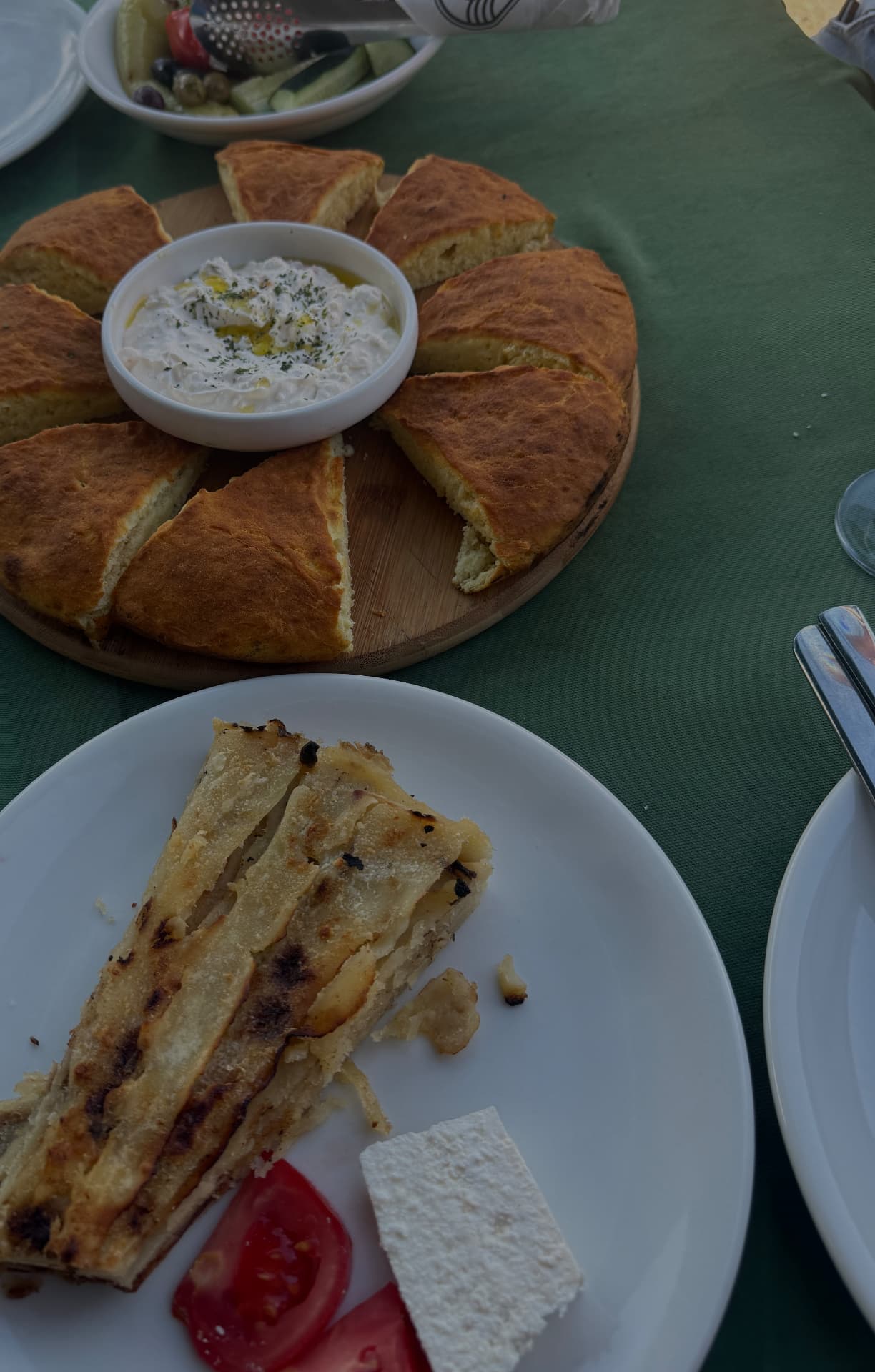 Flija and homemade bread with cheese and tomato on a village table in Kosovo