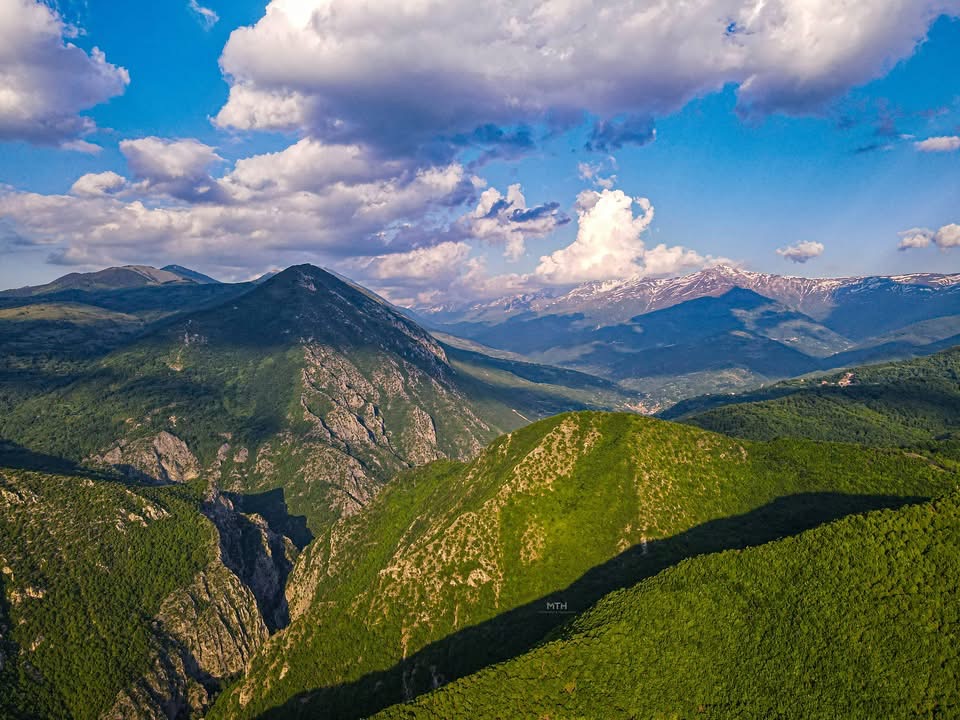 Aerial view of forested ridges and a deep canyon above Peja in western Kosovo