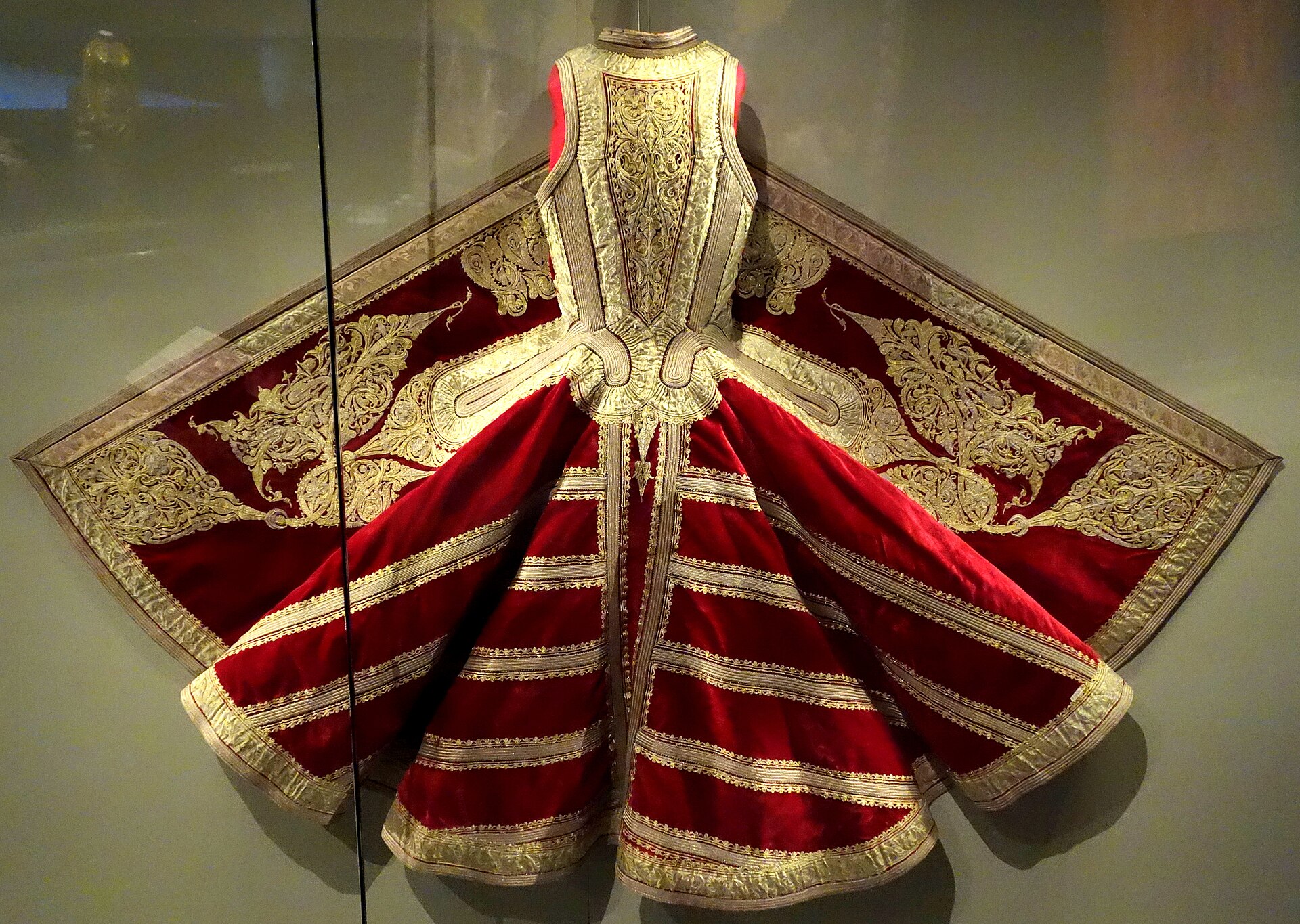 A nineteenth-century Albanian sleeveless jacket densely embroidered with gold and silver thread in swirling geometric patterns